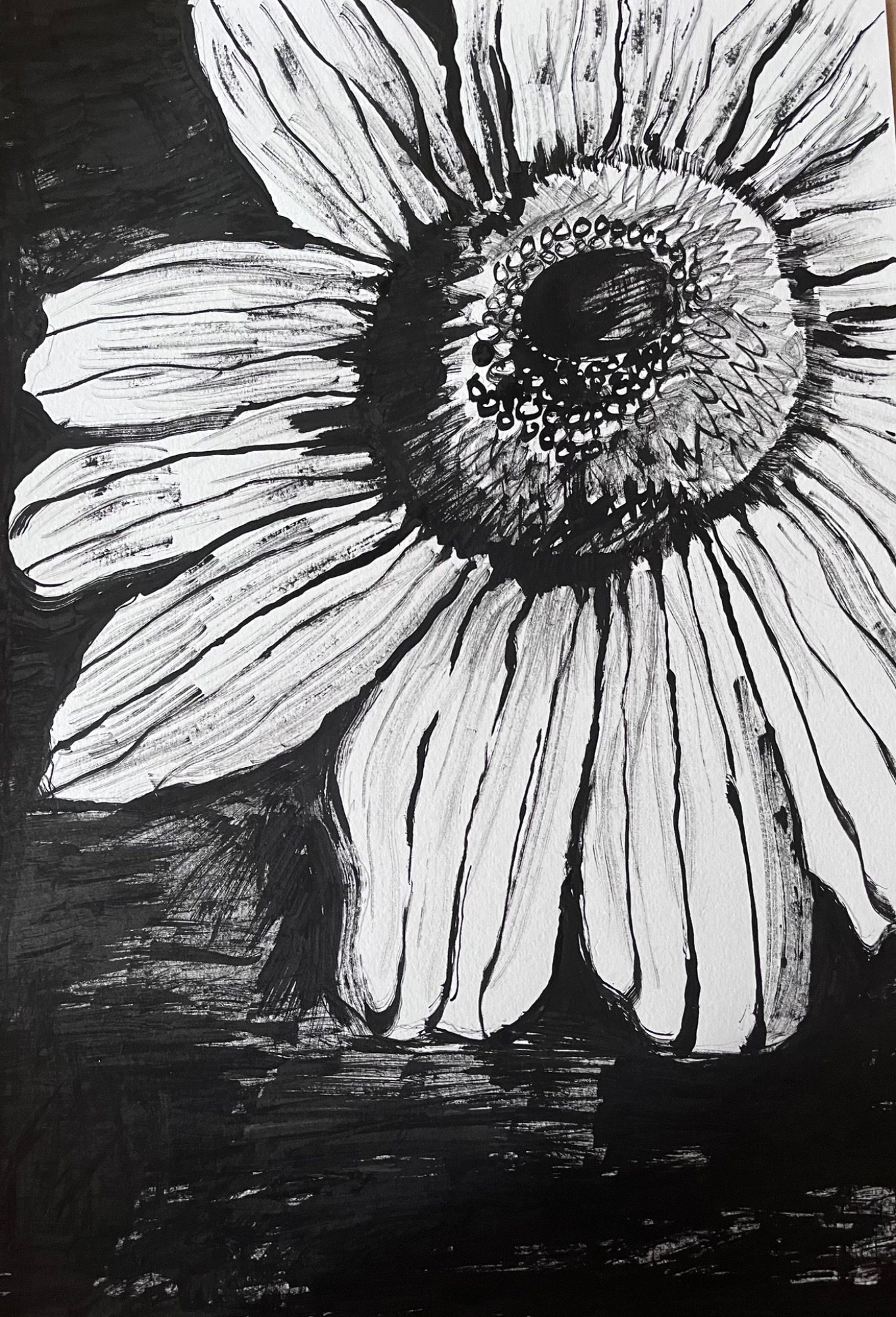 Black and white illustration of a sunflower, highlighting its petals and center.